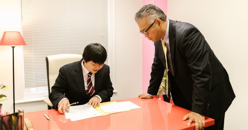 Global Business Etiquette Guide; Two businessmen discussing work in a modern office environment.